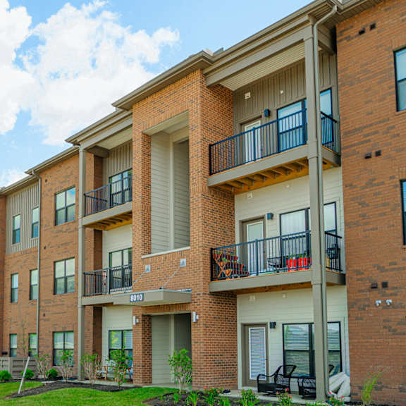 the outlook of a brick apartment building with balconies