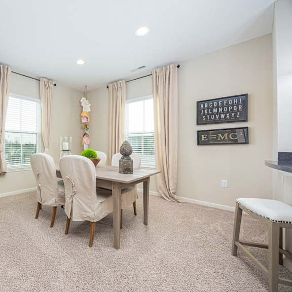 a dining room with a table and chairs.