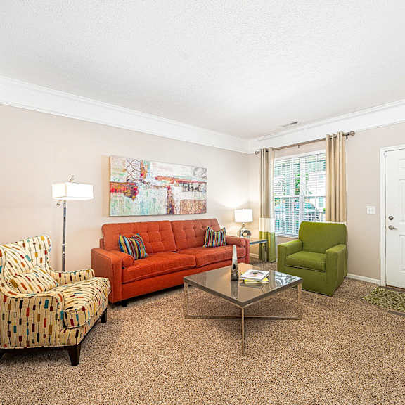 a living room with a couch and chairs and a table