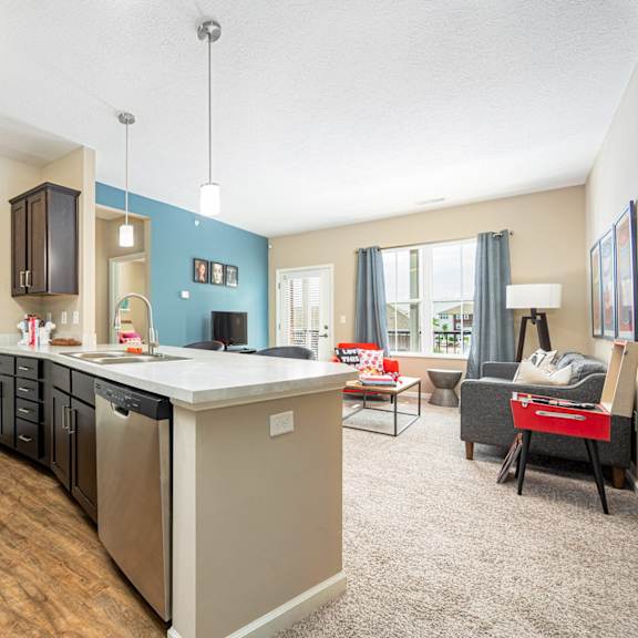 a kitchen and living room with a couch and a table