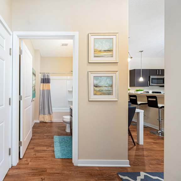 a hallway with a door to a kitchen and a living room