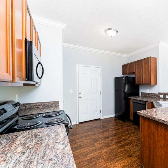 a kitchen with a black stove top oven and a black refrigerator.