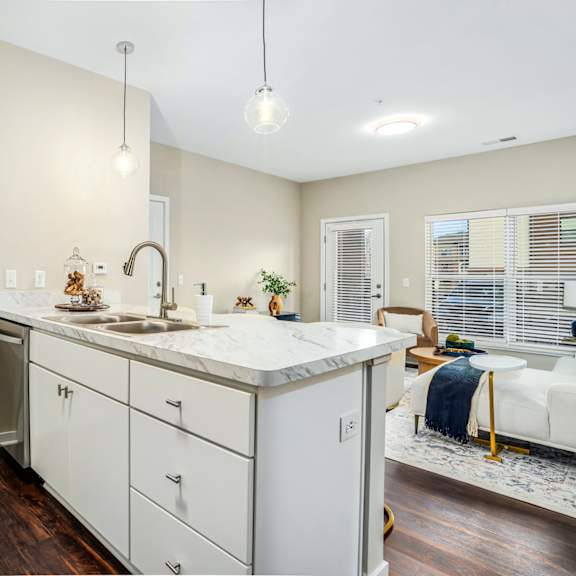 a renovated kitchen with white cabinets and a counter top