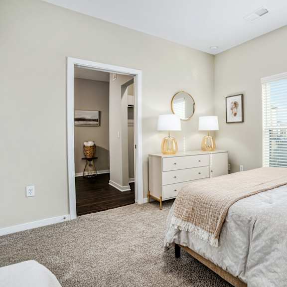 a bedroom with a bed and a large window