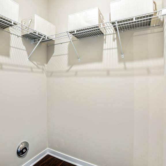 the spacious walk in closet in the master bedroom of a home with a mirrored wall