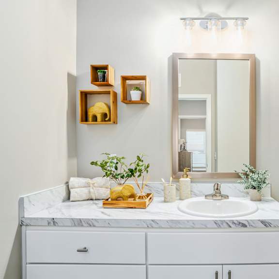 a white bathroom with a sink and a mirror