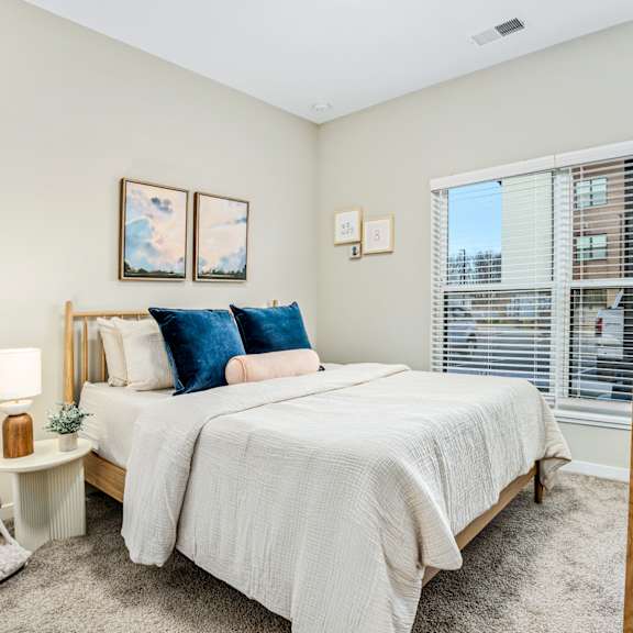 a bedroom with a large bed and a large window