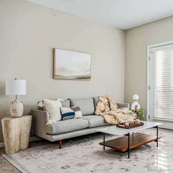 a living room with a couch and chairs and a coffee table