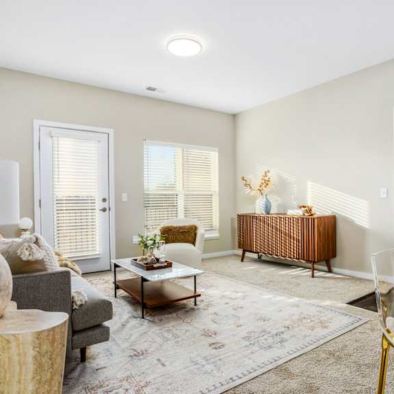 a living room with a couch and chairs and a table