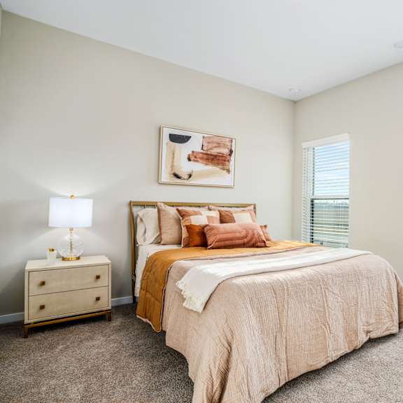 a bedroom with a bed and two windows