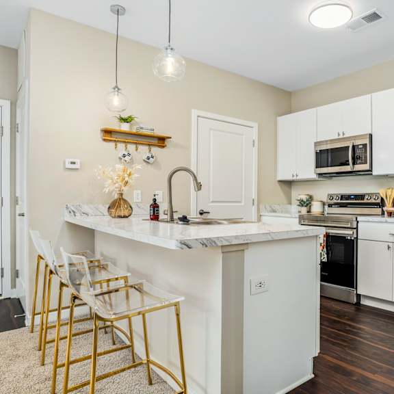 a kitchen with stainless steel appliances and a marble counter top