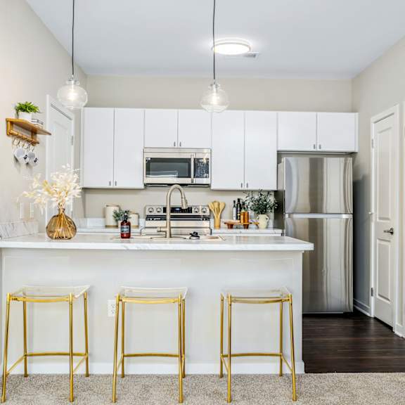 a kitchen with white cabinets and a white counter top