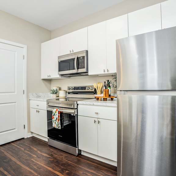 a kitchen with stainless steel appliances and white cabinets