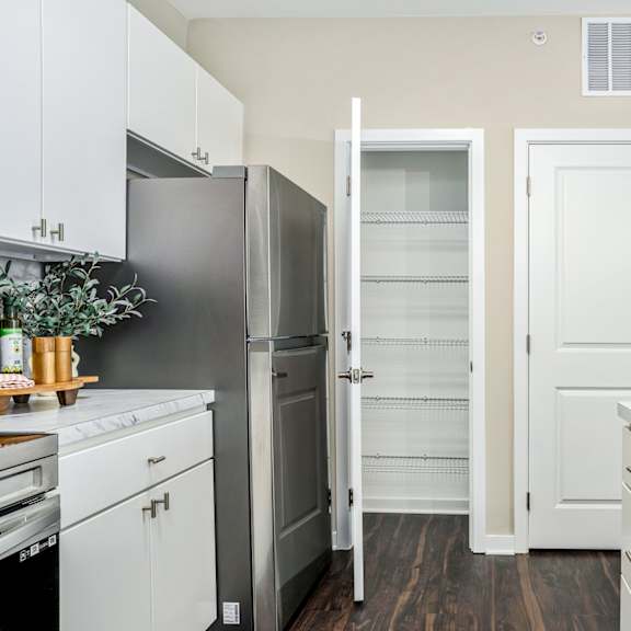 a renovated kitchen with white cabinets and stainless steel appliances
