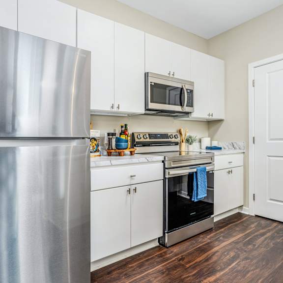 a kitchen with pink and white walls and a stove