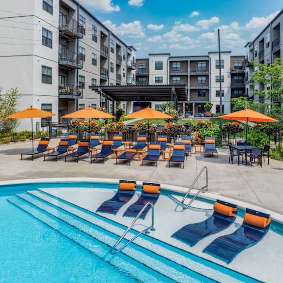 our apartments have a large pool with chairs and umbrellas