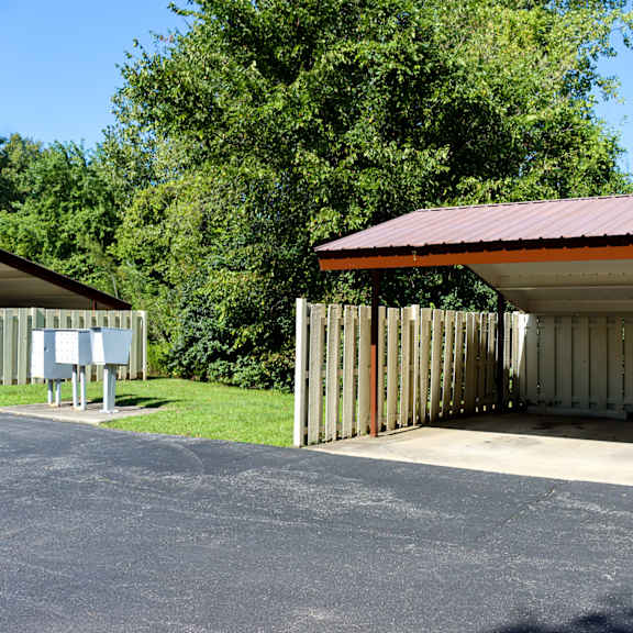 a covered parking garage with a red roof