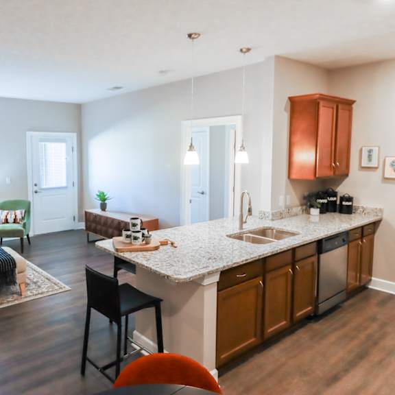 a living room and kitchen with a couch and a table