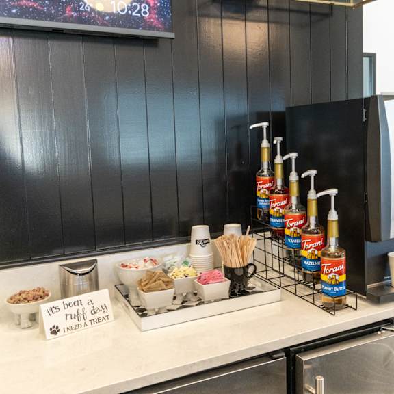 a kitchen counter with a tray of food and a coffee machine