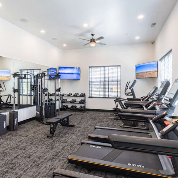 the gym with treadmills and cardio equipment at the belgard apartments