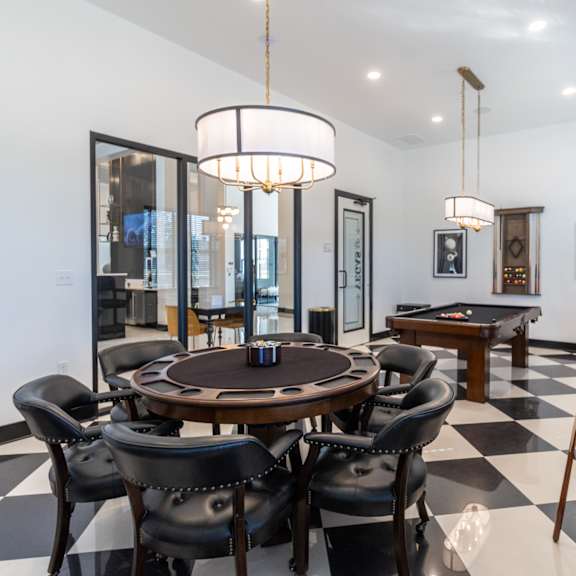 a dining room with a table and chairs and a pool table