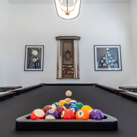 a billiards table with a bunch of balls on it