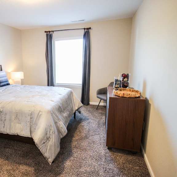 a bedroom with a bed and a desk