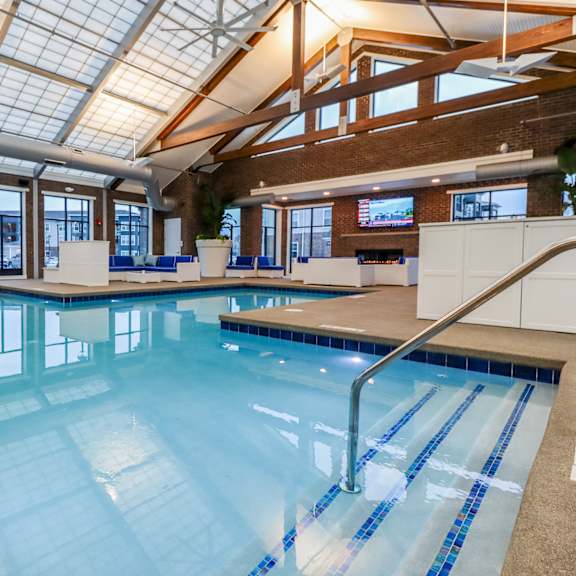 a large indoor swimming pool with a glass ceiling