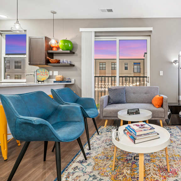 a living room with a couch and chairs and a television