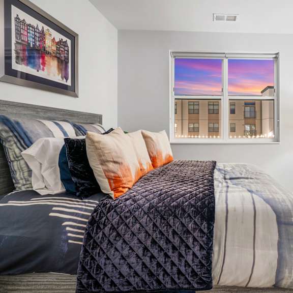 a bedroom with a bed and a window