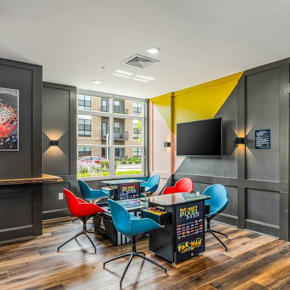 a game room with a table and chairs and a tv