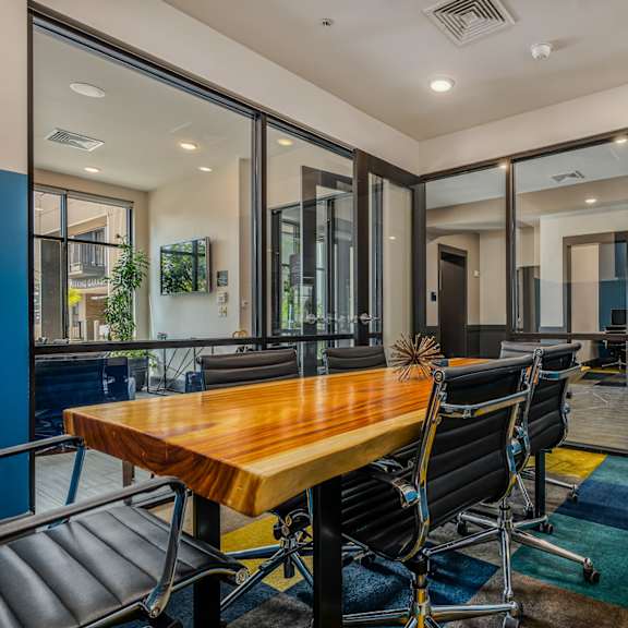 a conference room with a wooden table and chairs