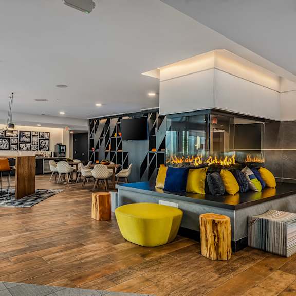 the lobby of a hotel with a bar and tables