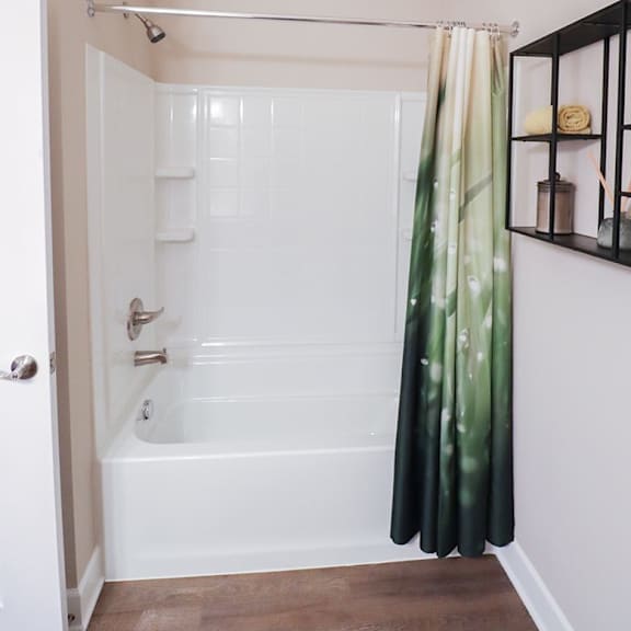a bathroom with a white tub and a shower curtain