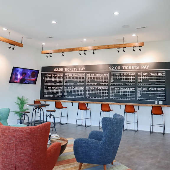 a lobby with chairs and a large board on the wall