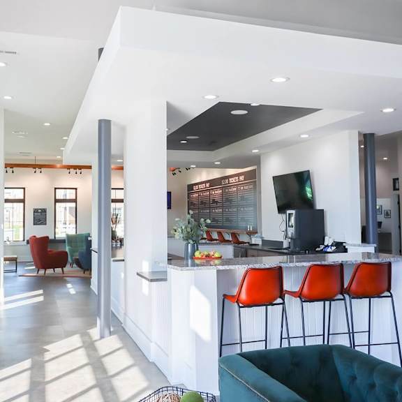 a living room with a bar and a kitchen