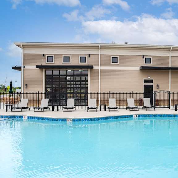 a swimming pool in front of a resort building