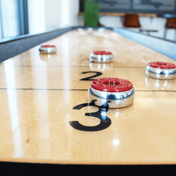 a shuffleboard court with red and white balls on it
