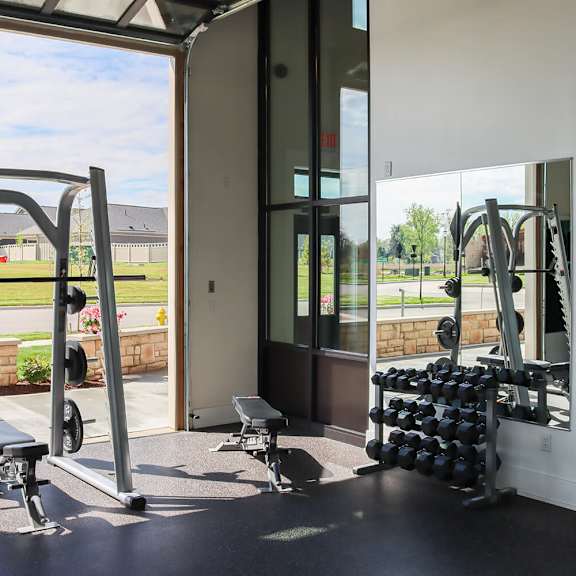 a gym with weights and a window in a building