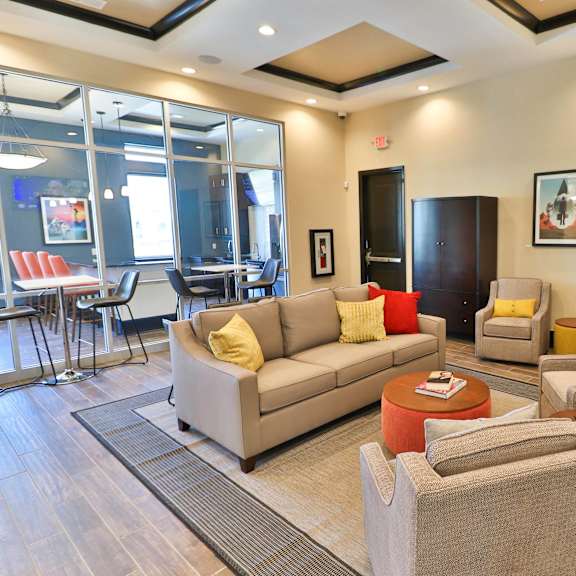 a living room with couches and chairs and a coffee table