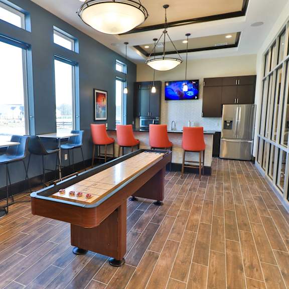 a game room with a pool table and chairs