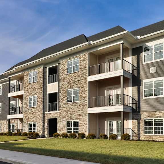 an exterior view of an apartment building on a sunny day