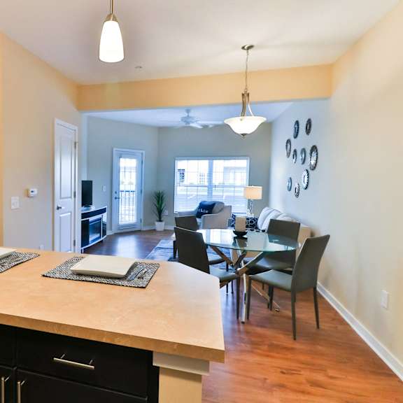 a kitchen and dining area with a table and chairs and a large counter top