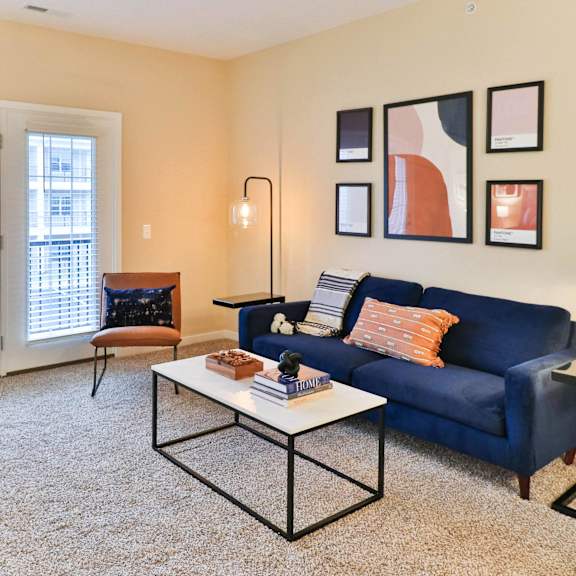a living room with a blue couch and a coffee table