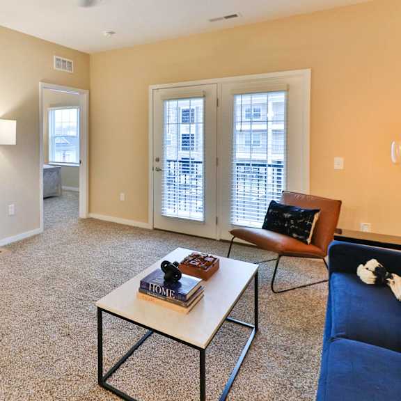 a living room with a couch and a coffee table and a television
