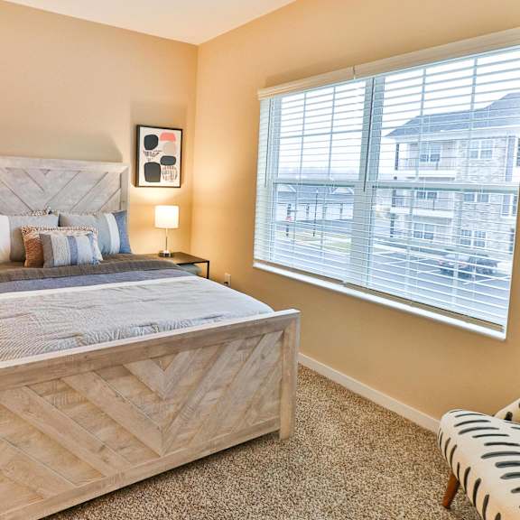 a bedroom with a bed and a window