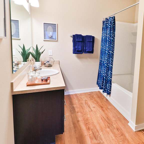 a bathroom with a shower and a sink and a toilet
