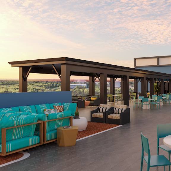 a patio with a table and chairs is set up on a rooftop.