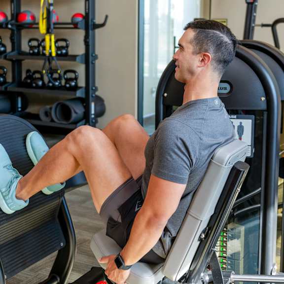 a man working out on a machine in a gym