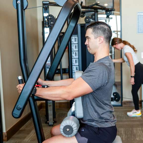 a man working out on a machine in a gym